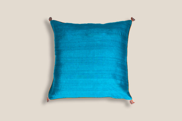front of an exclusive ocean silk cushion with tassels