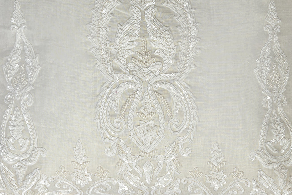 detail of an Exclusive soft neutral cushion with white sequins design