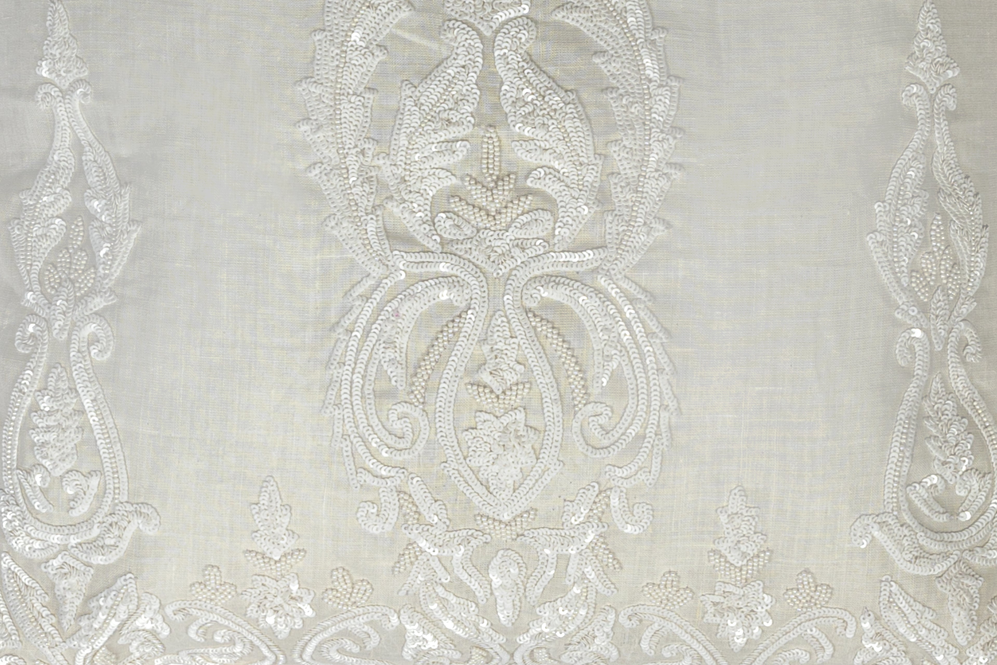 detail of an Exclusive soft neutral cushion with white sequins design