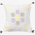front of a white luxury cushion cover with multicolour leaves